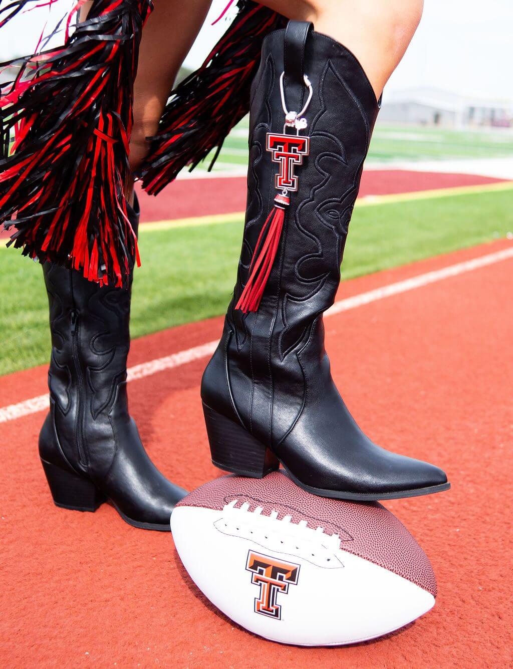 Cowgirl boots and football on track.