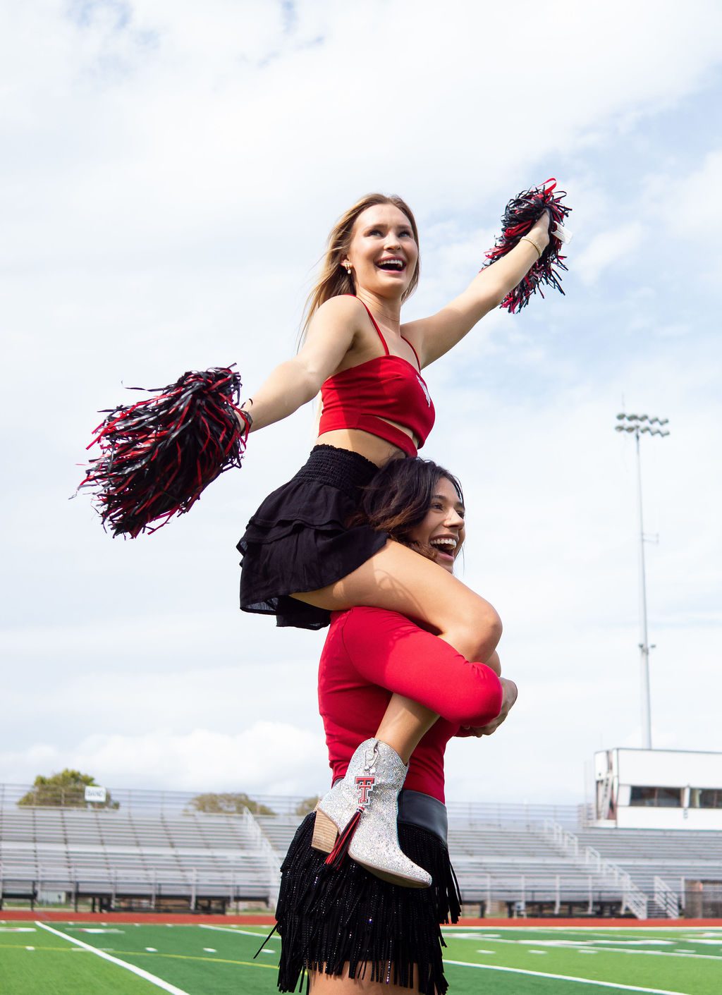 Cheerleaders performing on a football field.