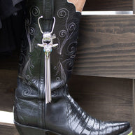 Black cowboy boot with the stainless steel Mizz Boot Bola Steer Skull Accessory. 